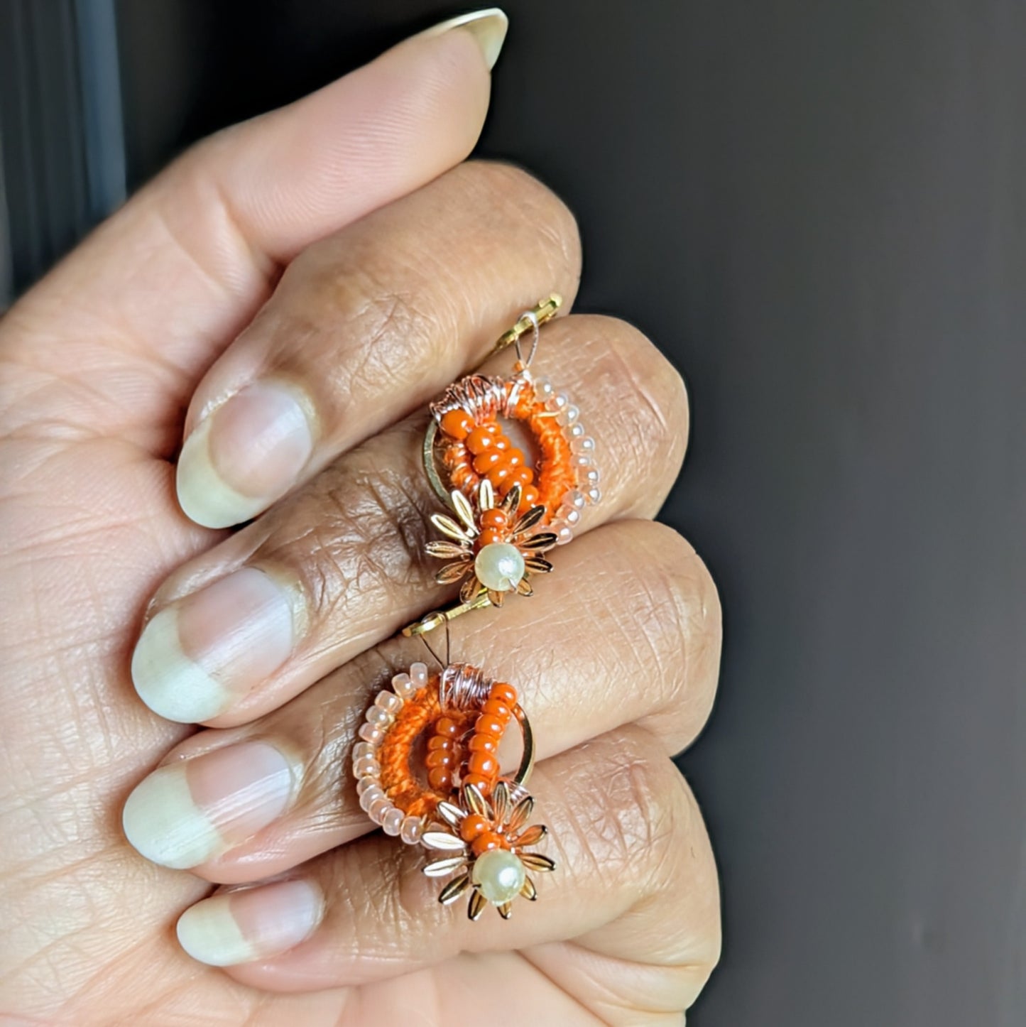 Hypoallergenic handmade orange earrings featuring vintage seed beads and pearls.
