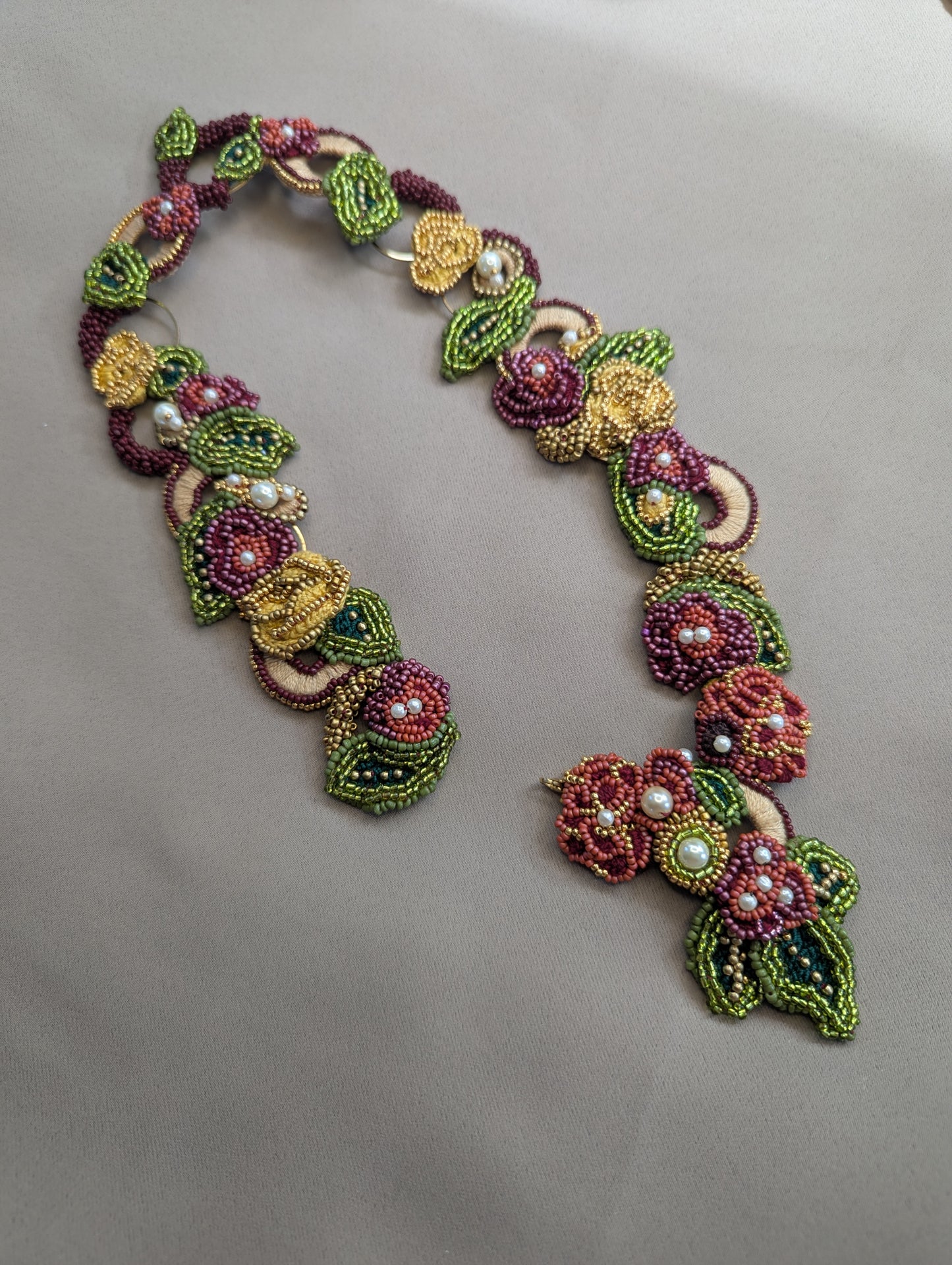 Rukmini floral inspired intricately woven statement necklace handmade in the UK for Mayaani Jewellery featuring a front facing clasp.