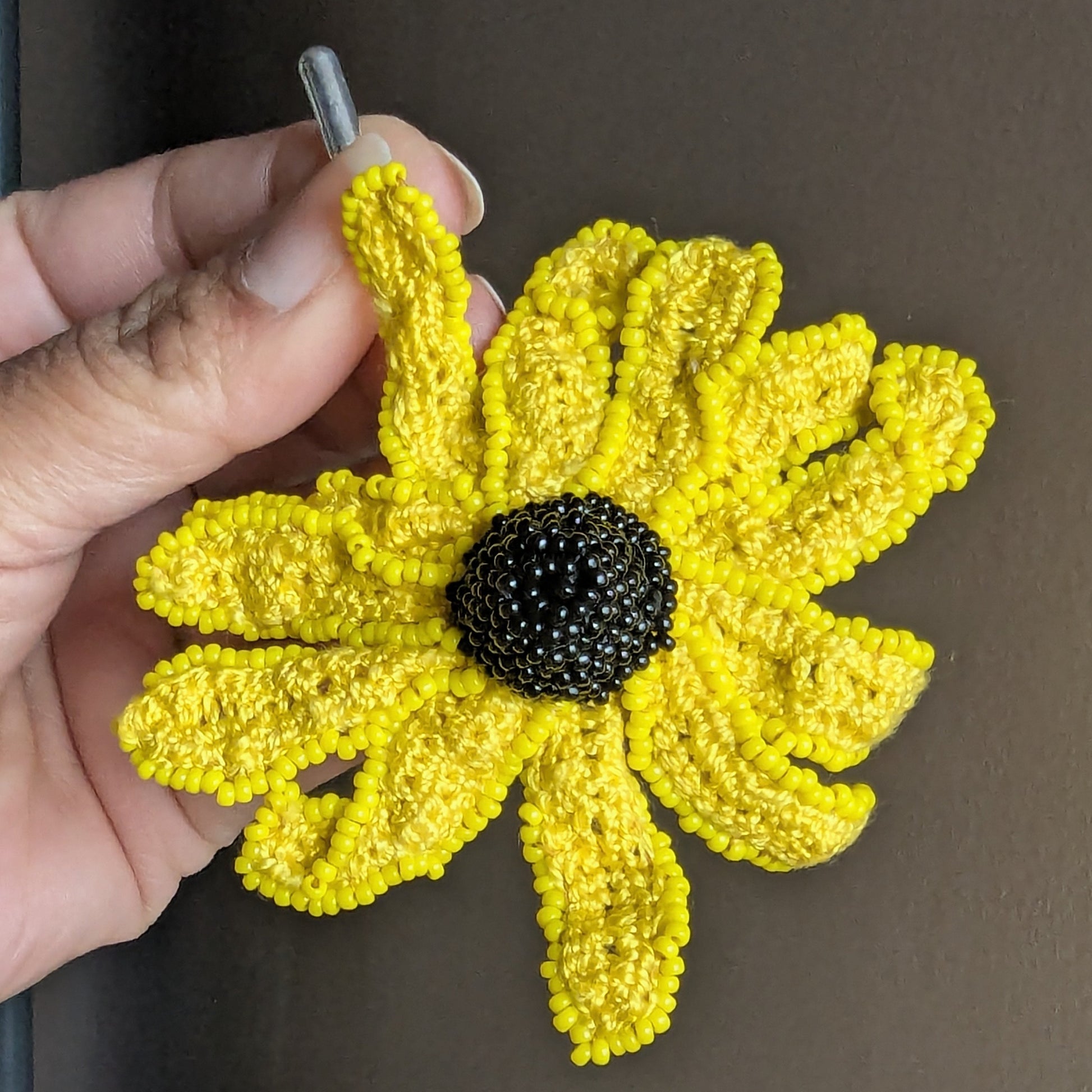 Vamika brooch close up - sunshine yellow Egyptian cotton petals with black sculptural centre.