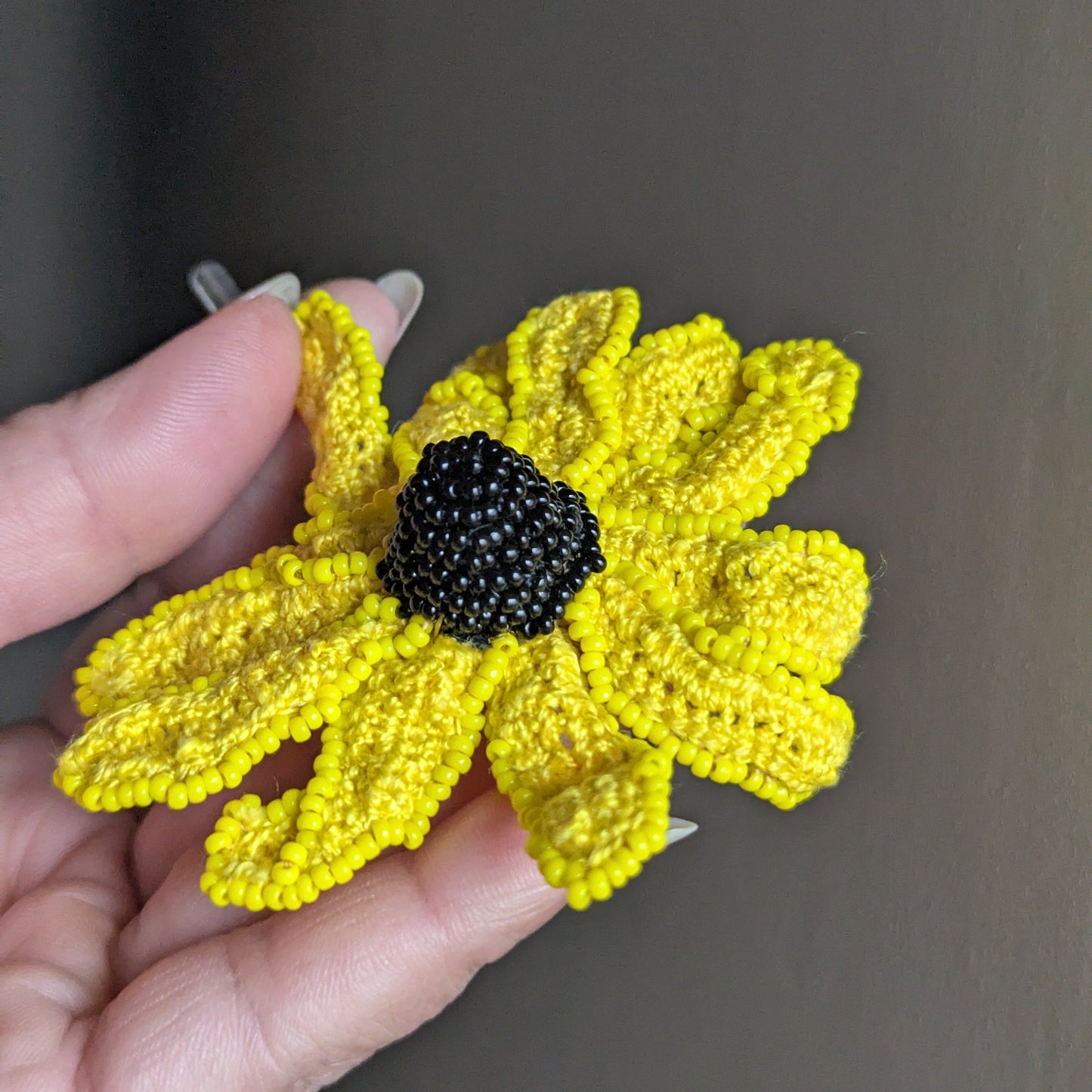 Vamika rudbeckia brooch angled view - textured yellow cotton petals spreading naturally.