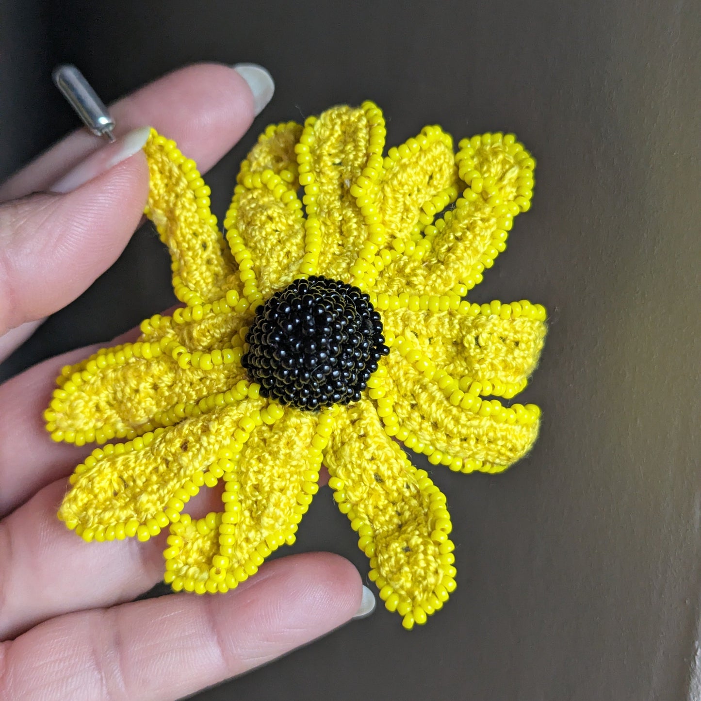 Vamika floral brooch full view - sunshine yellow petals with black glass seed bead centre.