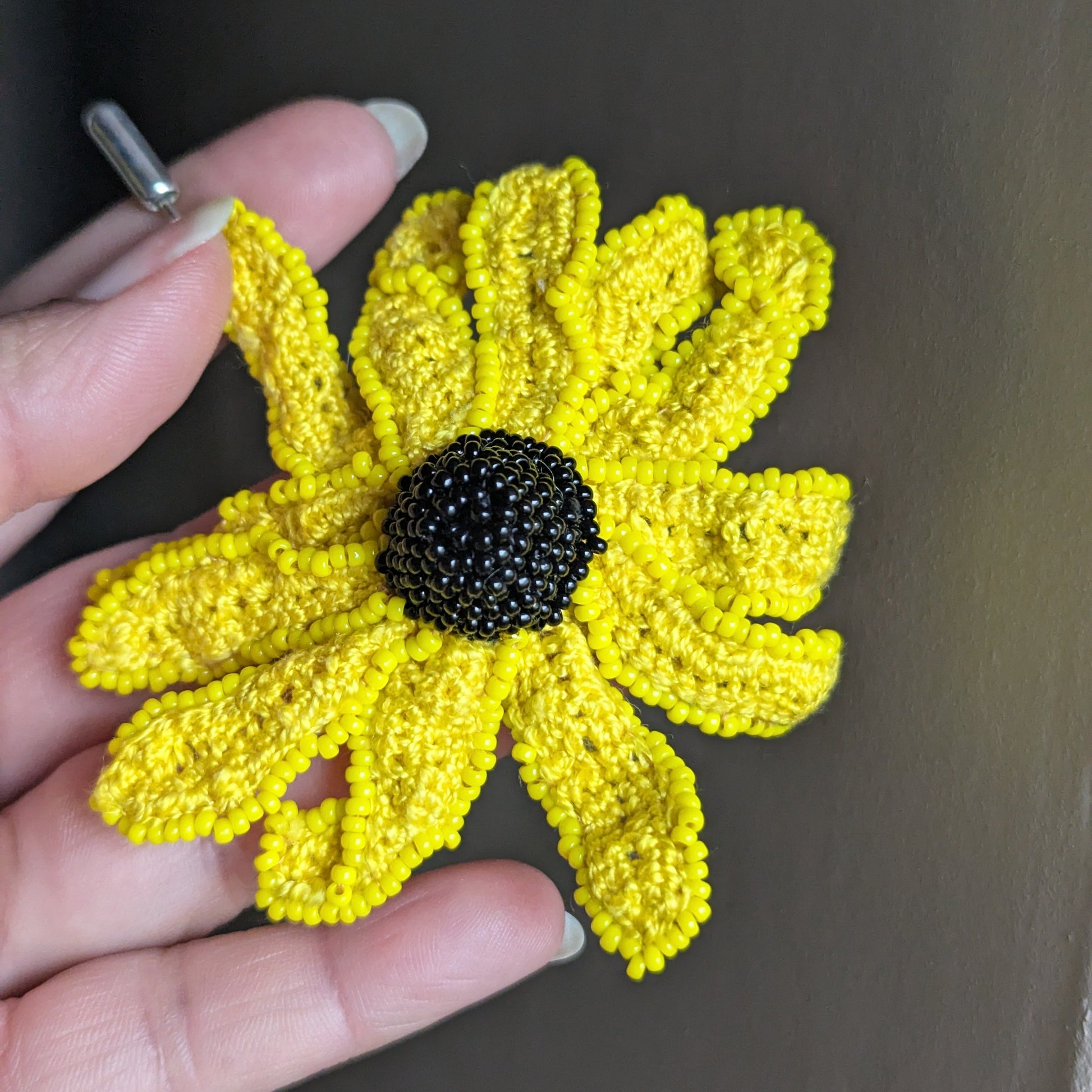 Vamika floral brooch full view - sunshine yellow petals with black glass seed bead centre.
