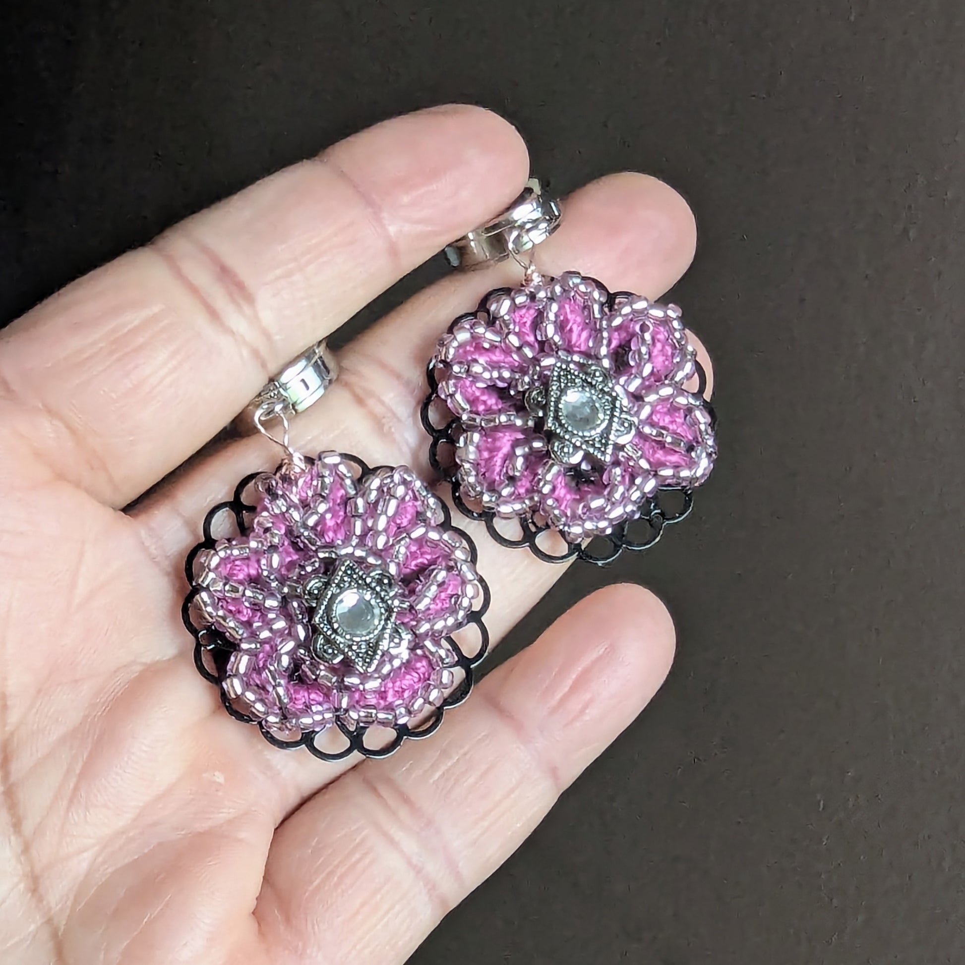 Side view of Vanya handmade pink earrings showing layered beadwork and filigree structure.