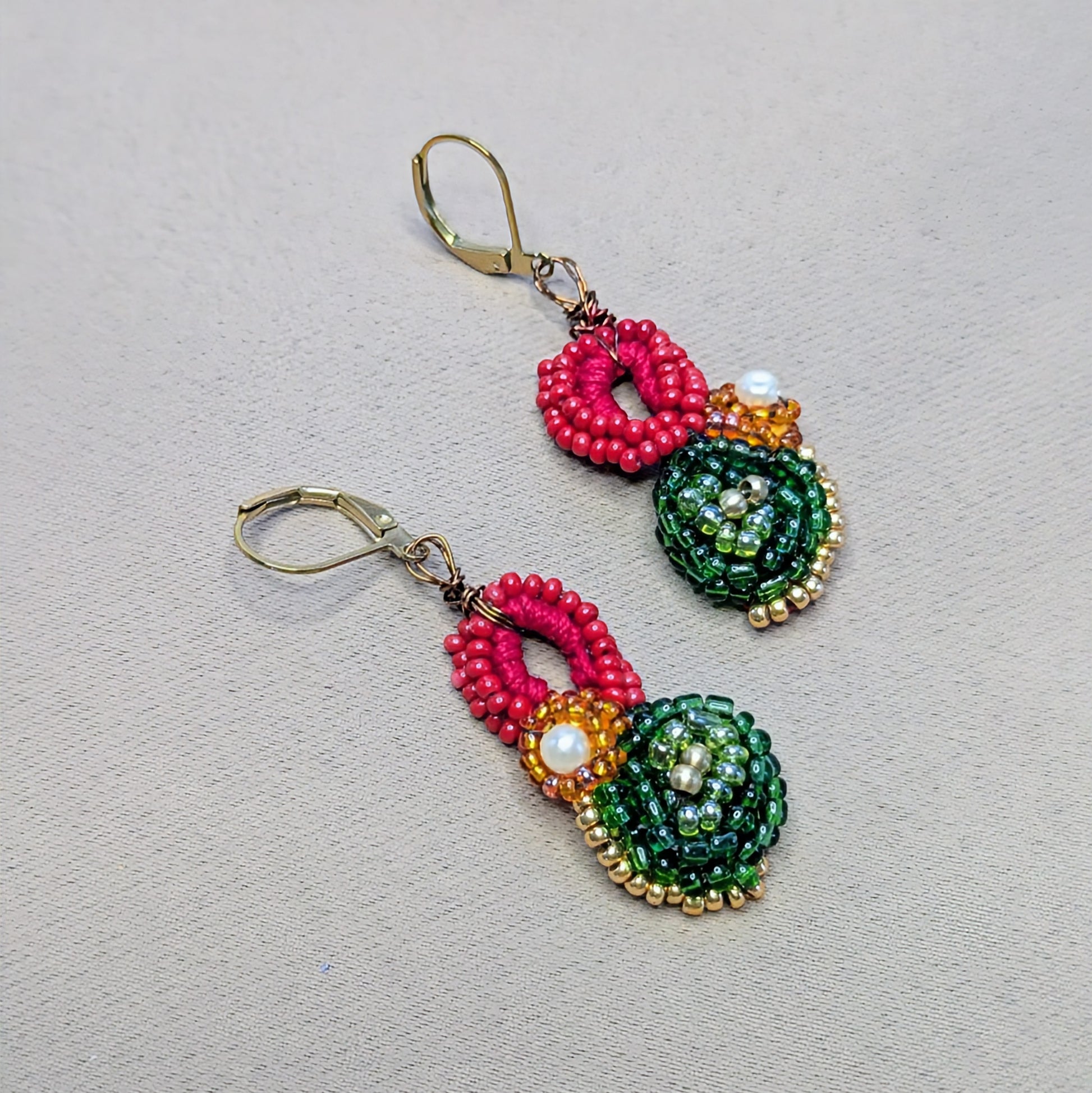 One of a kind Vasanta beaded earrings with pearl centre and emerald green detail.