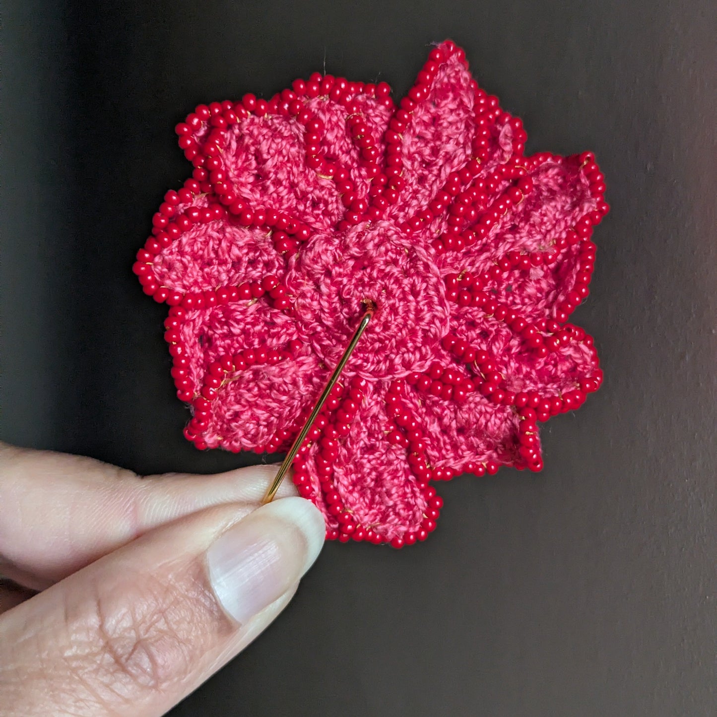 Back view of the one of a kind Zinnia flower bead crochet brooch from Mayaani Jewellery UK - sustainably handmade for the modern diaspora woman.
